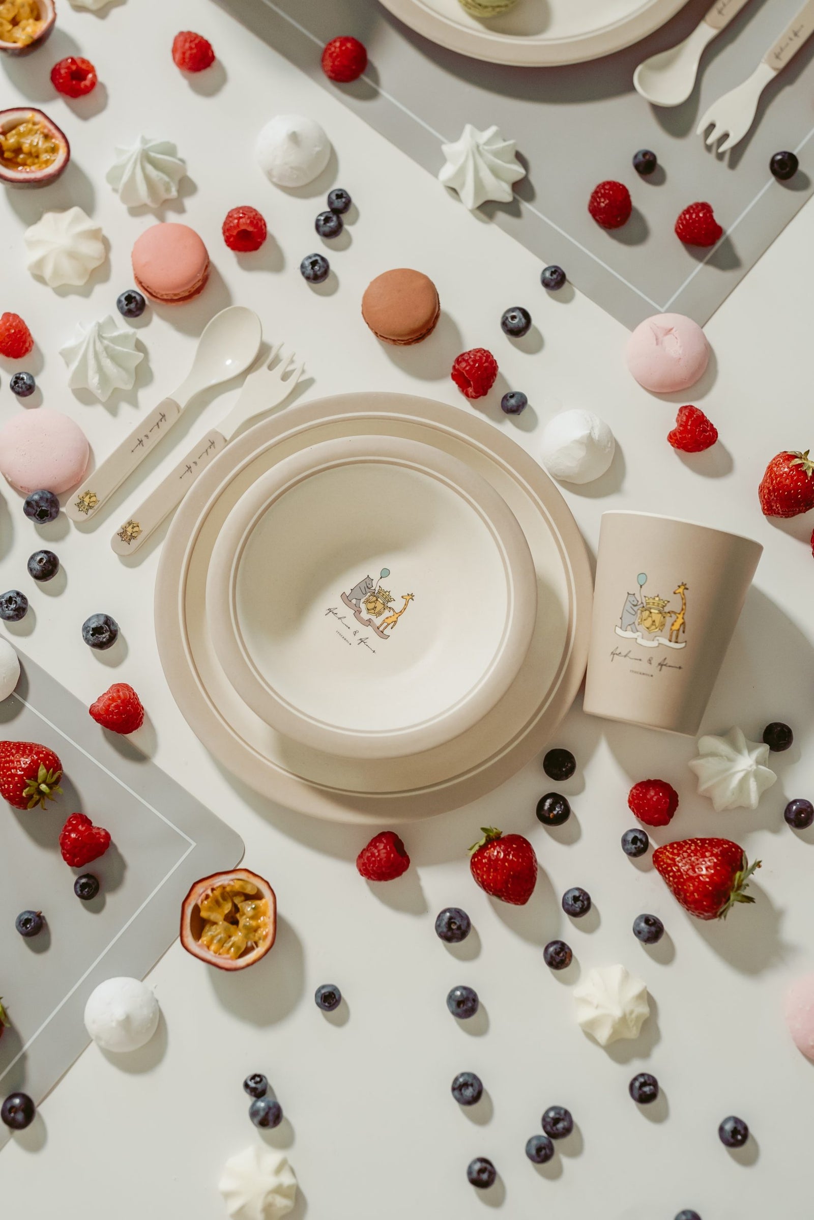 Monogram table set, cup and placemats on a table with berries